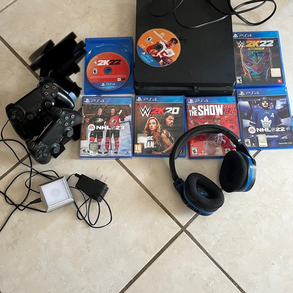 PlayStation 4 with 2 controllers, 7 games, headphones, and controller charger